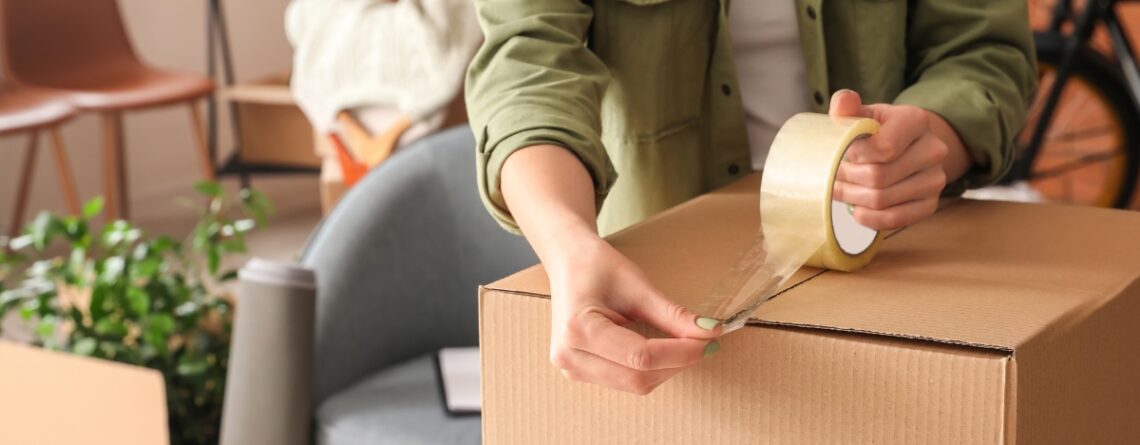 Taping up a cardboard box ready for storage