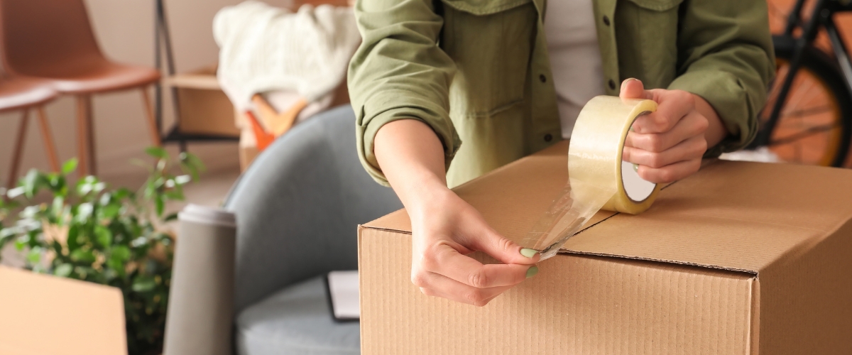 Taping up a cardboard box ready for storage