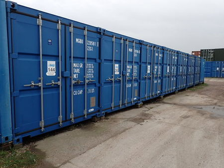 Row of blue shipping container storage units